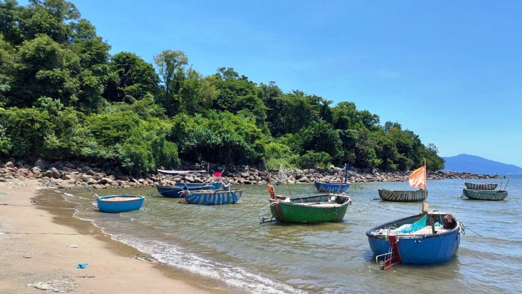 Rocky reefs and blue sea at Nam O beach, Da Nang